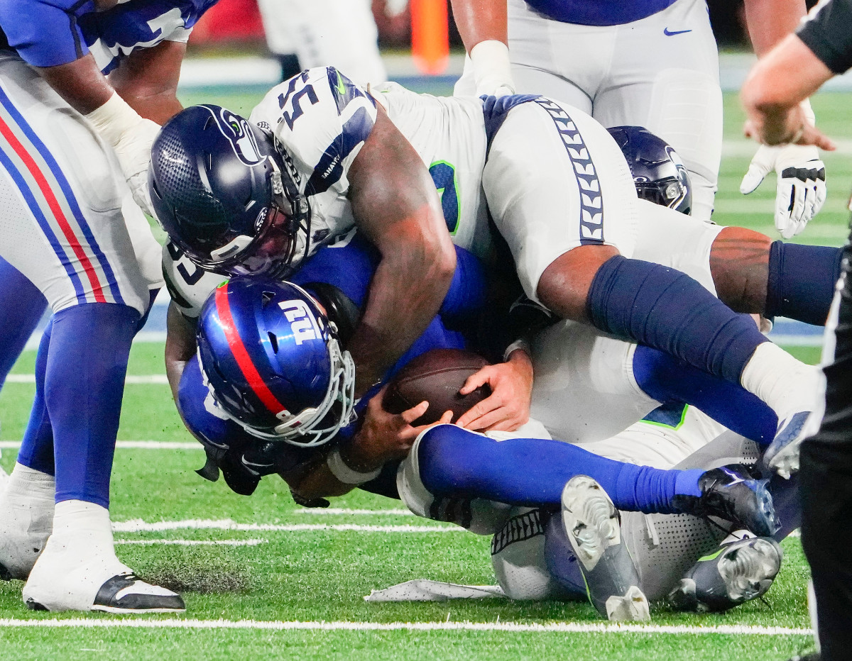 Seattle Seahawks defensive end Dre'Mont Jones (55) and linebacker Uchenna Nwosu (10) sack New York Giants quarterback Daniel Jones (8) in the second half at MetLife Stadium. 